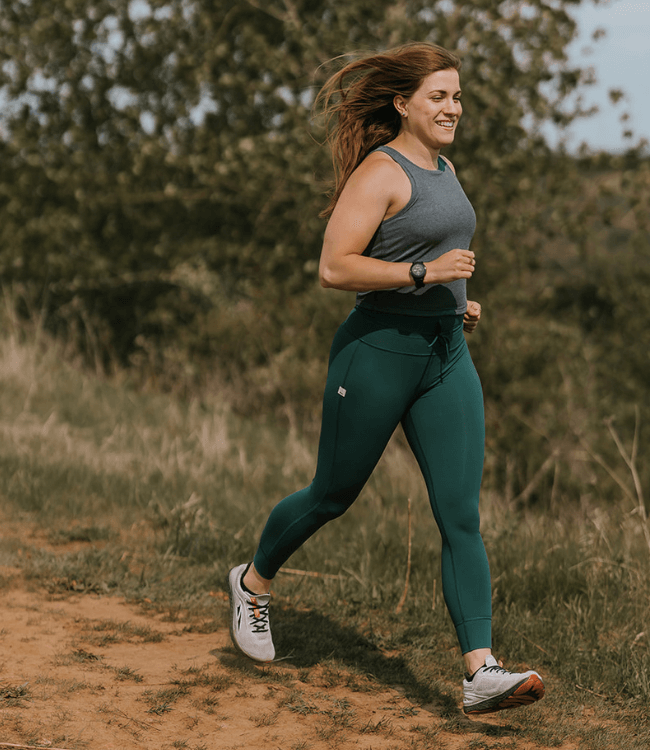 A woman running on the trails